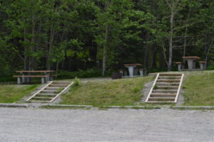 stairs into grass up hill to picnic tables