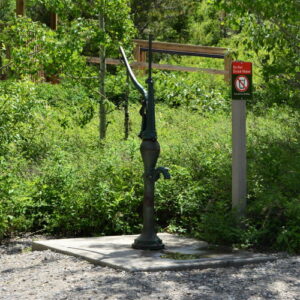 old, rusty, green hand water pump